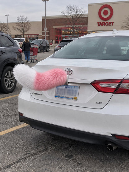 Pink & White | Wagride tail mounted at the rear of a parked car
